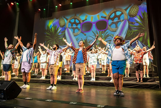 Indianapolis Men's Chorus performing their summer show with the embroidered number line laid along the front edge of the stage