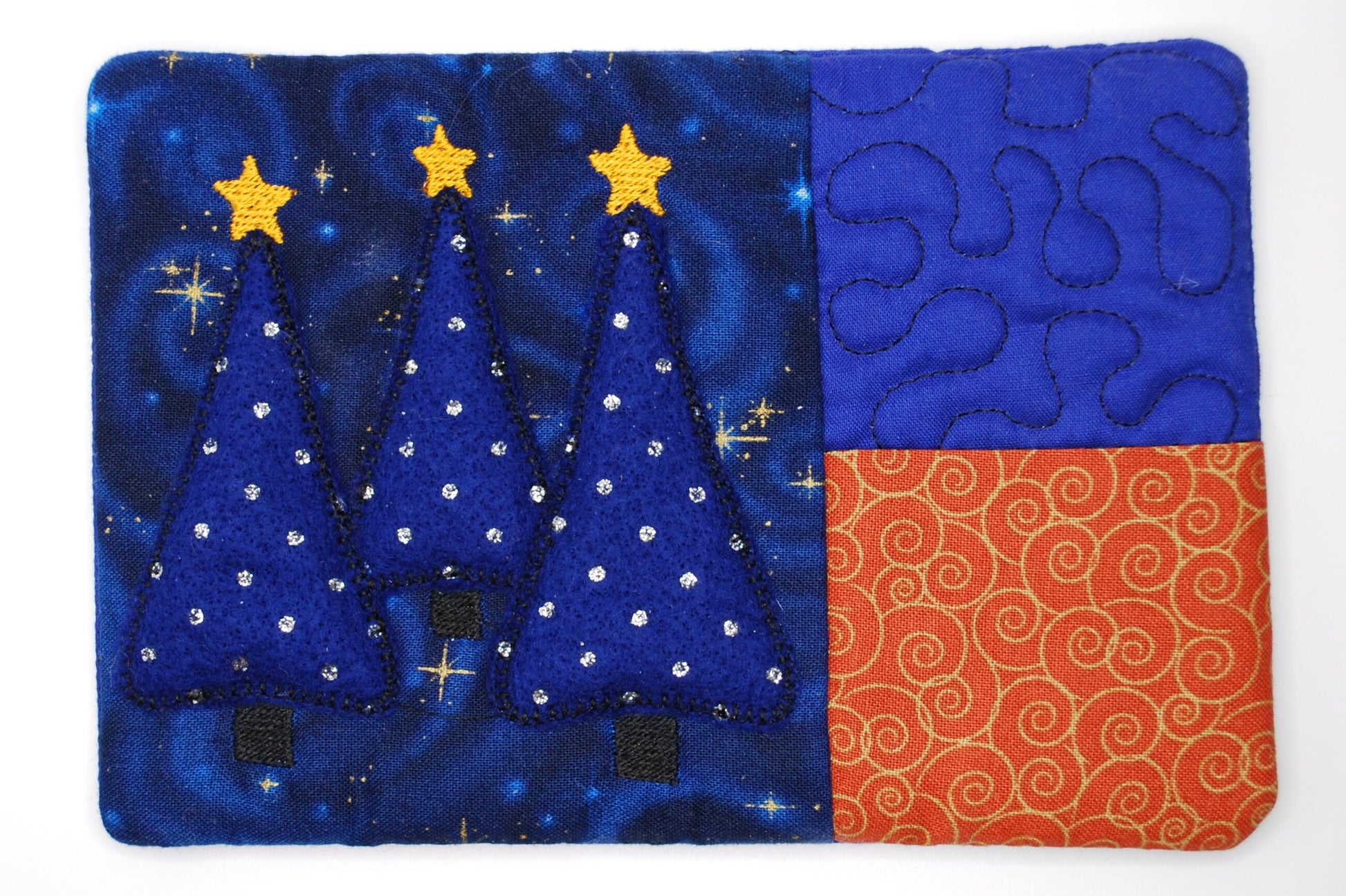 Felt A mug run with tree decoration, blue trees, stars, and orange pattern on a blue background