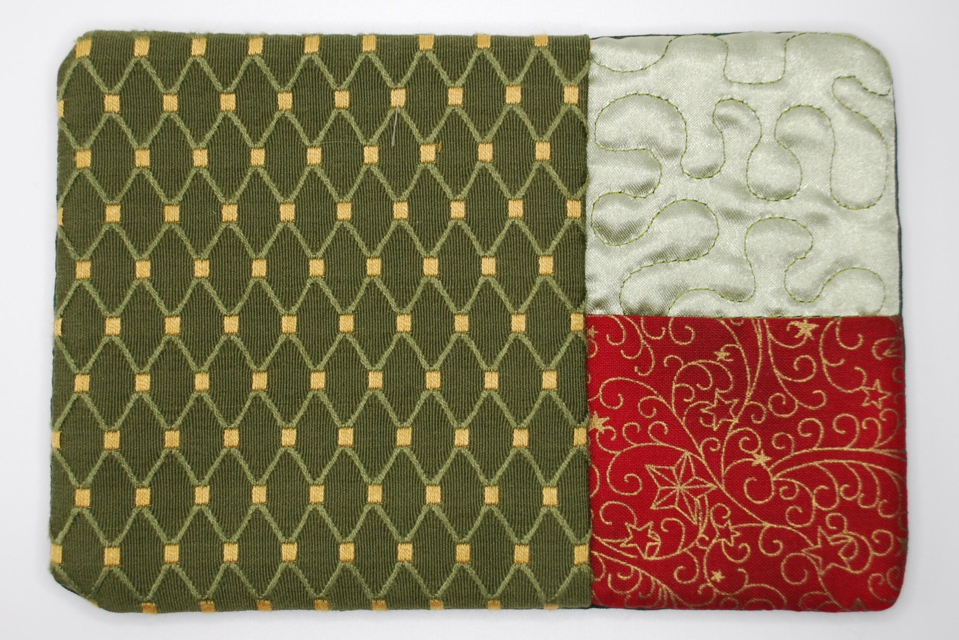 A mug run with green geometric pattern, white floral design, and red floral pattern on a white background