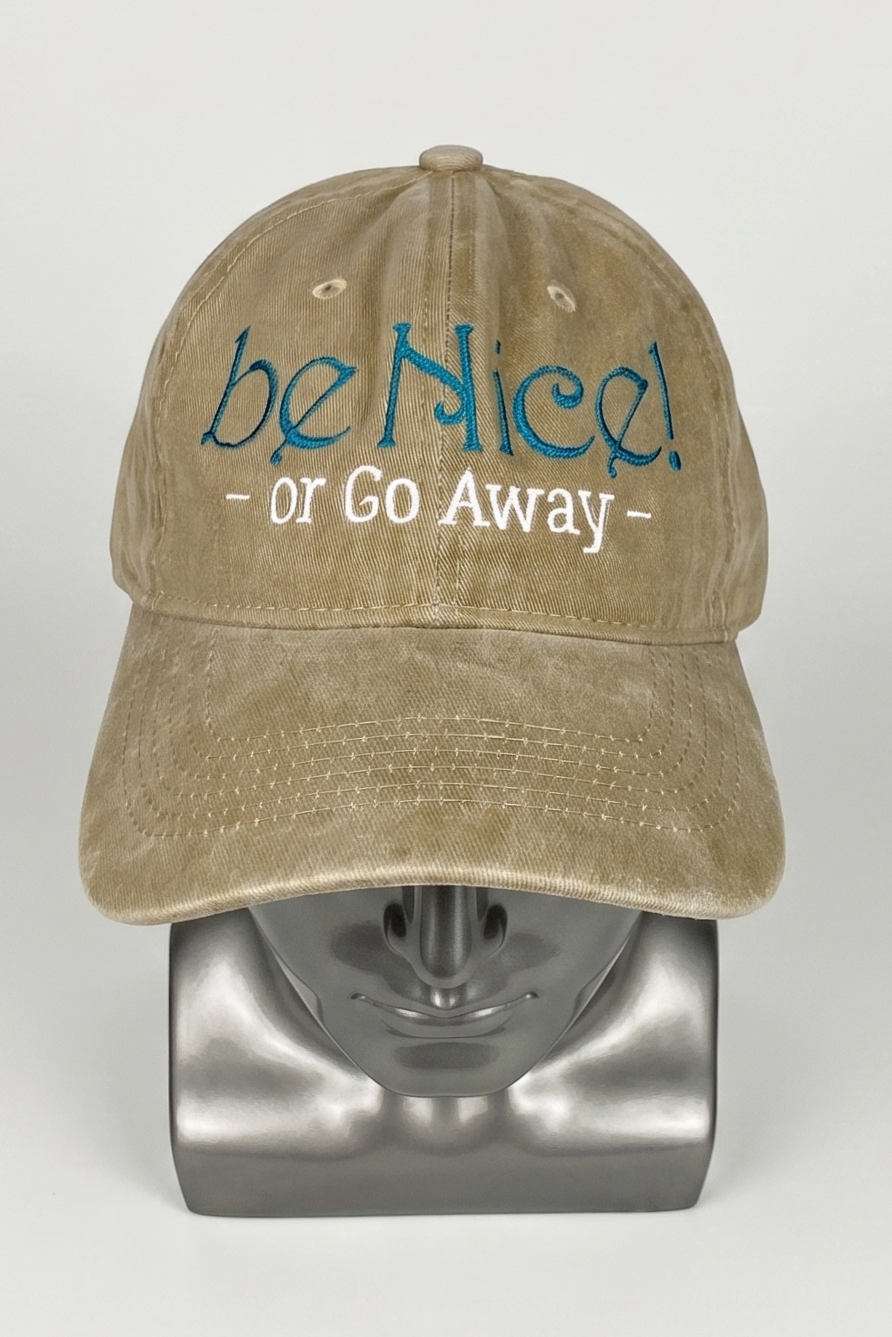 be Nice! or Go Away embroidered on a washed unstructured dad hat in teal and white thread