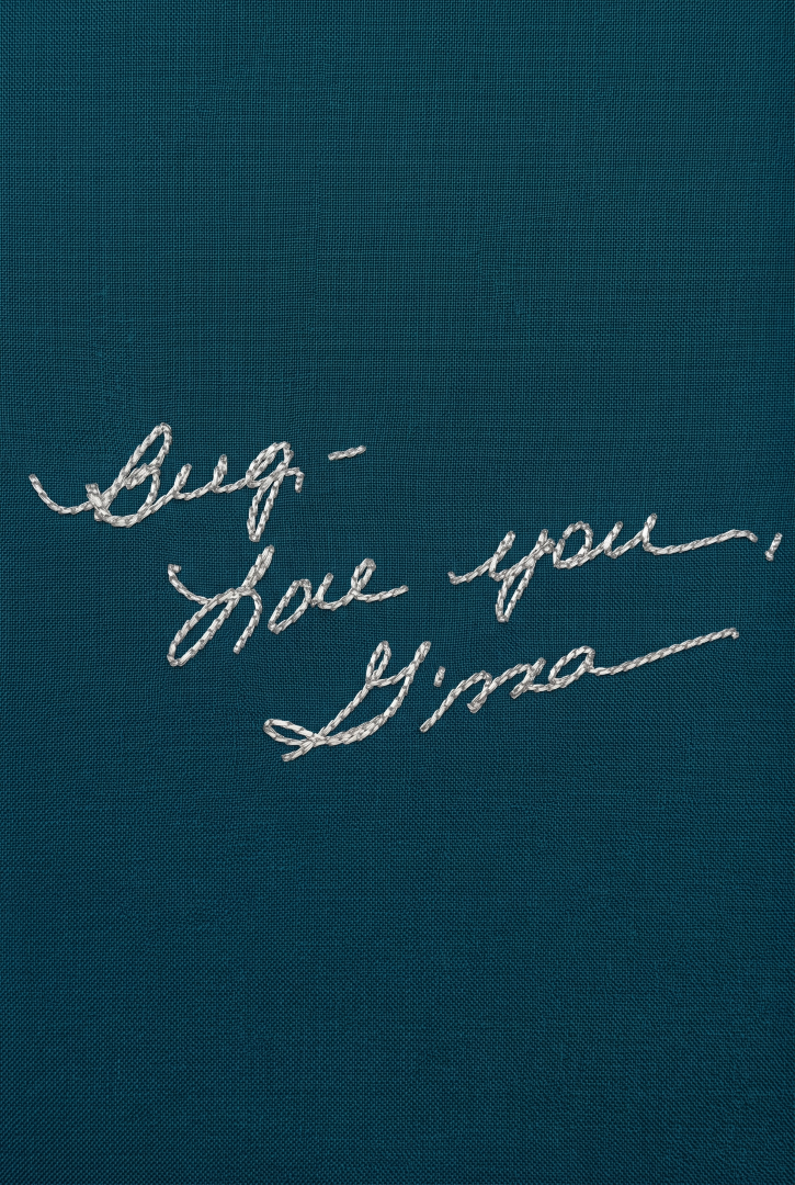 Embroidered text on a blue fabric background